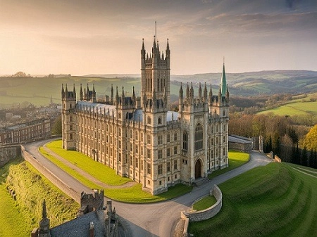 historic sherborne castle in england, a top destination, with lush green grounds and rolling hills under a warm sky.